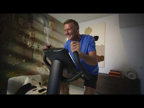 Video of the Flow Fitness B5s Premium Touchscreen Exercise Bike. Video shows a man exercising on bike in a luxury home. 